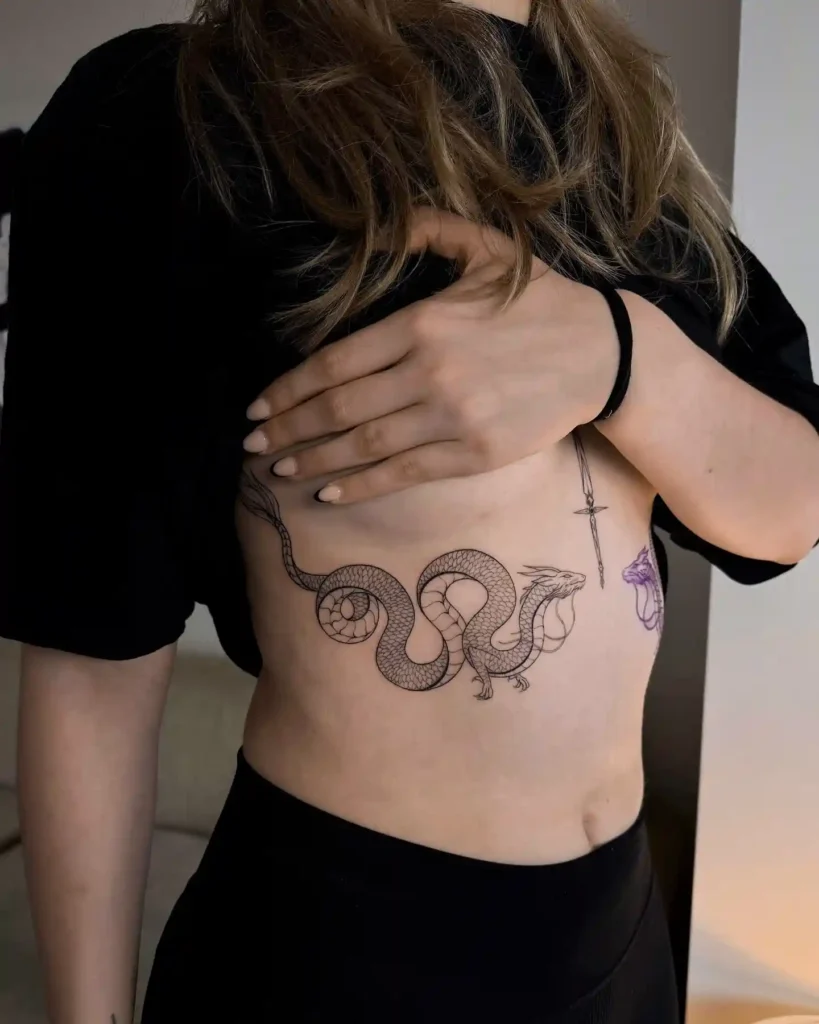 Long Serpent with Dragon Face Ribcage Tattoo