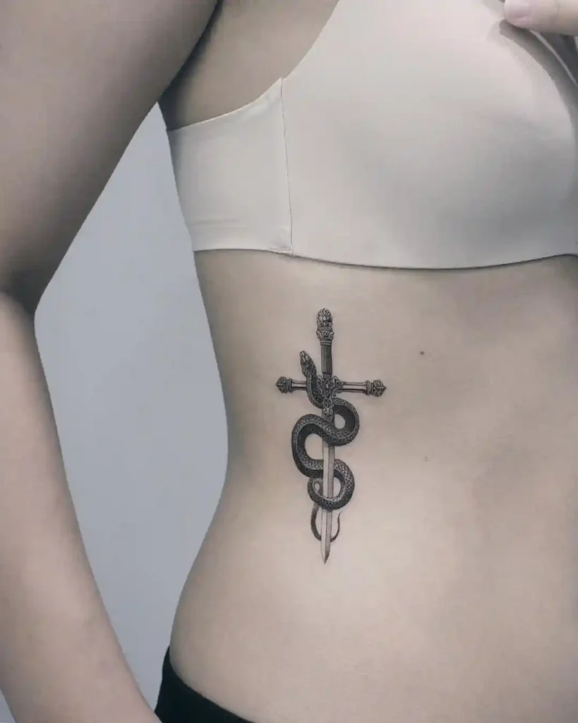 Sword and Serpent Ribcage Tattoo