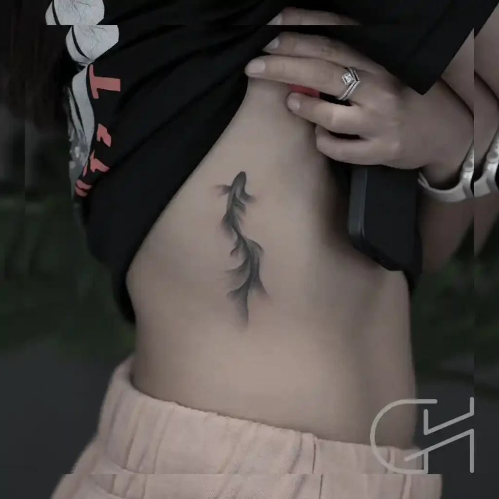 Dark Flowy Koi Fish Ribcage Tattoo