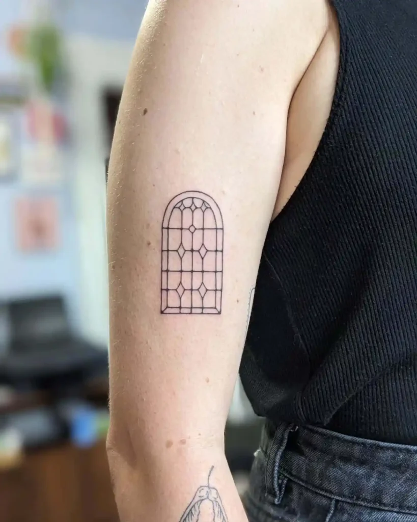 Arched Stained Glass Tattoo on Upper Arm