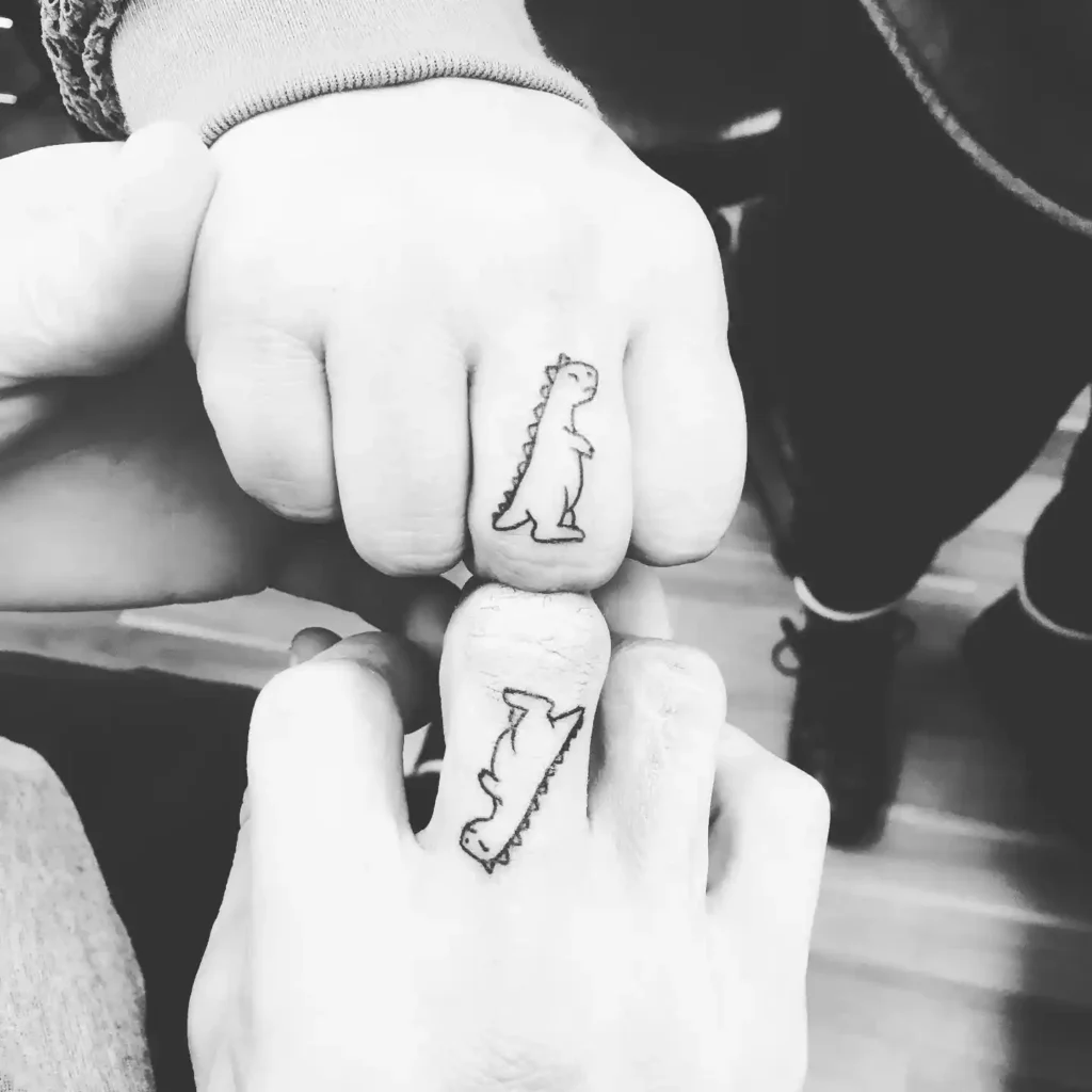 Tiny Finger Dinosaur Tattoos