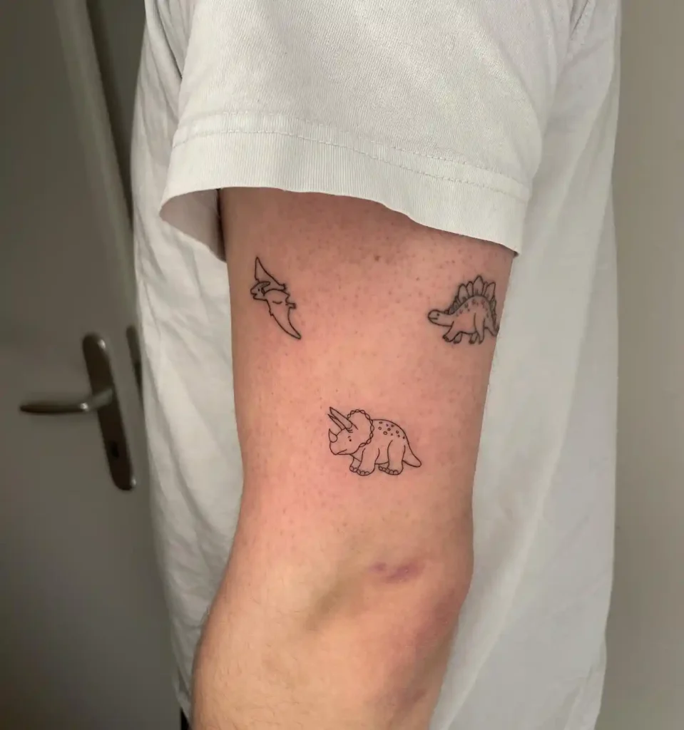 Minimalist Cartoon Dinosaurs Trio Tattoo