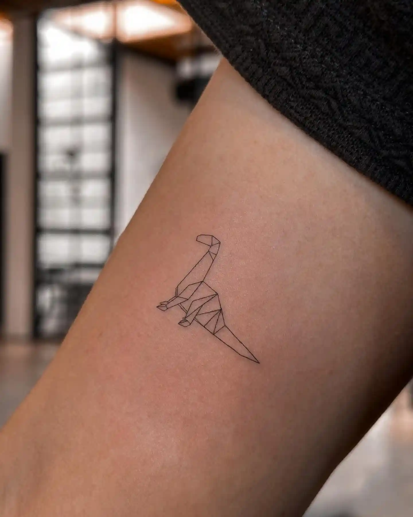 Minimalist Origami Dinosaur on Arm
