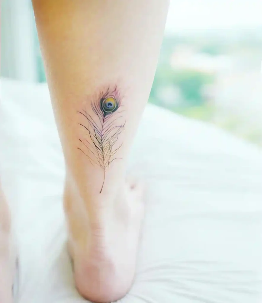 Dainty Micro-Realistic Peacock Feather Tattoo