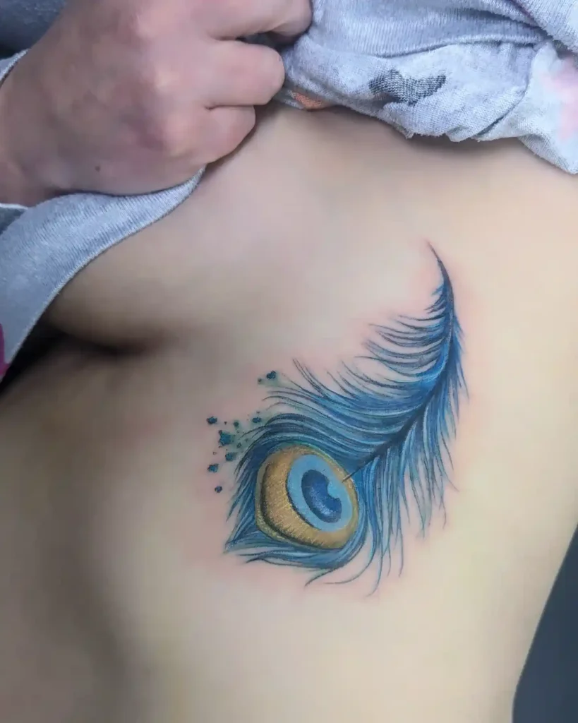 Vibrant Watercolor Peacock Feather Tattoo
