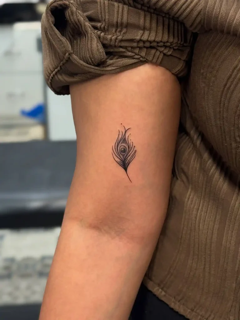 Minimalist Fine-Line Peacock Feather Tattoo