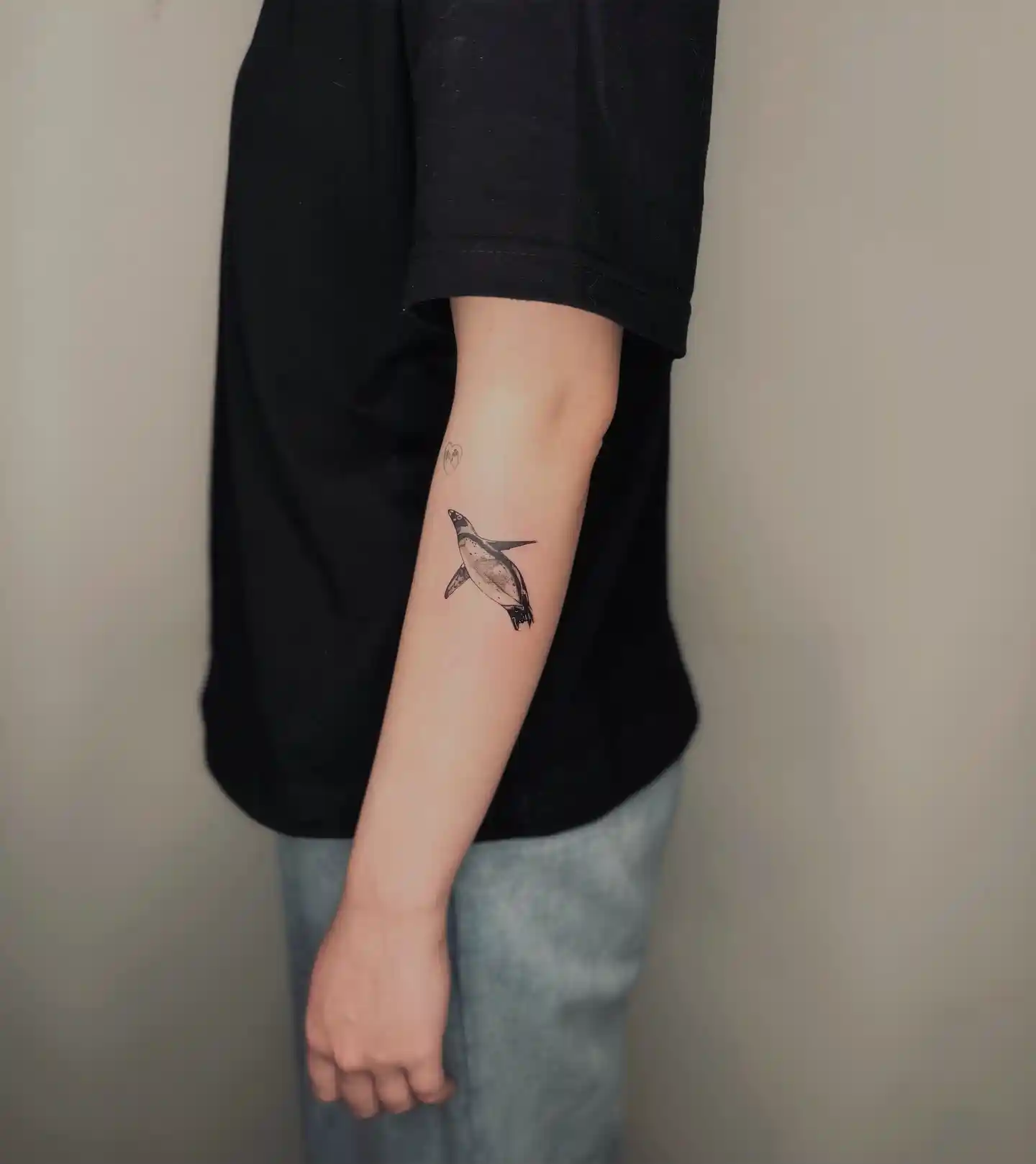 Graceful Swimming Penguin Tattoo