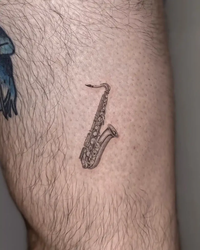 Tiny Realistic Saxophone Tattoo