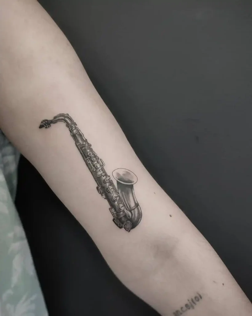Realistic Black and Grey Saxophone Tattoo
