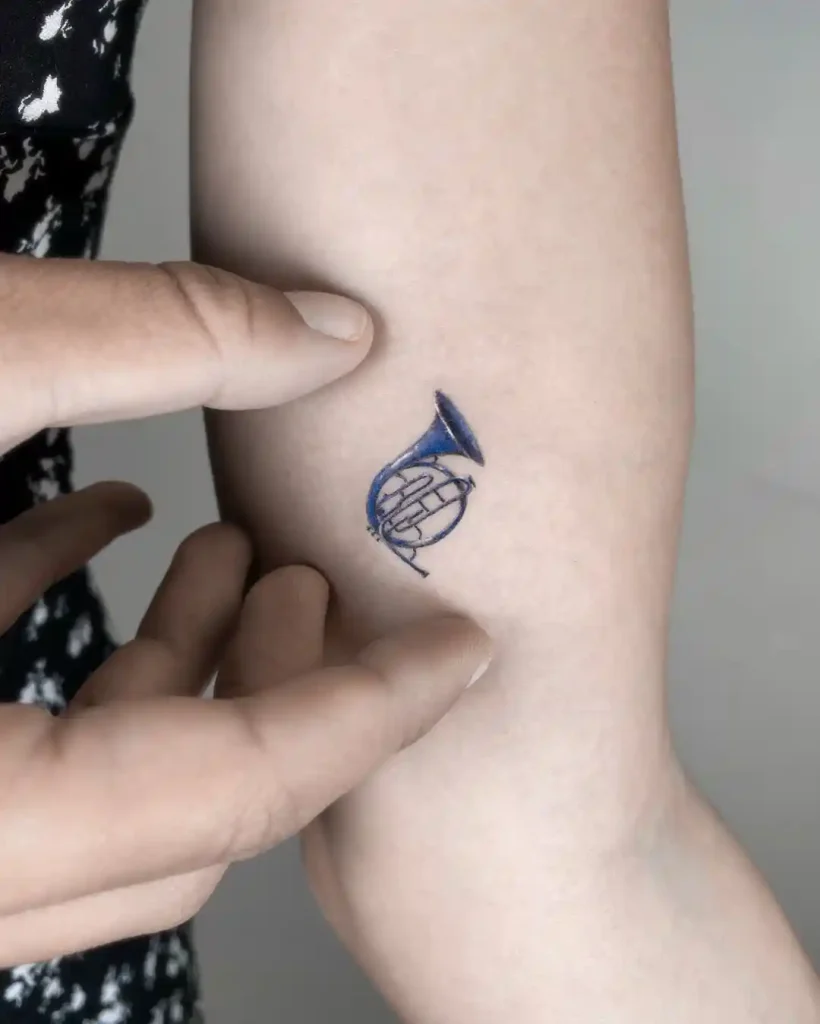 Tiny Blue French Horn on Arm