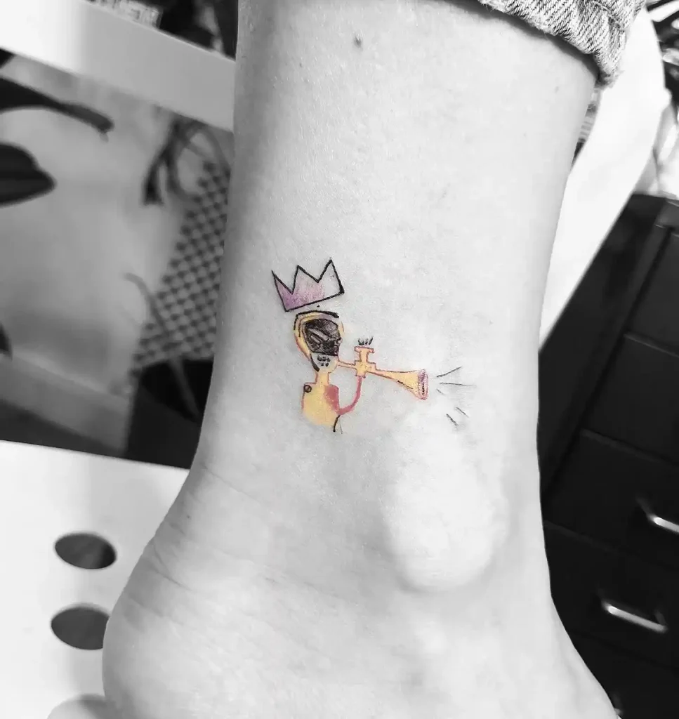 Small Basquiat-Style Trumpet Tattoo on Ankle