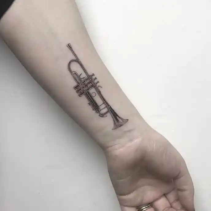 Small Detailed Trumpet Wrist Tattoo