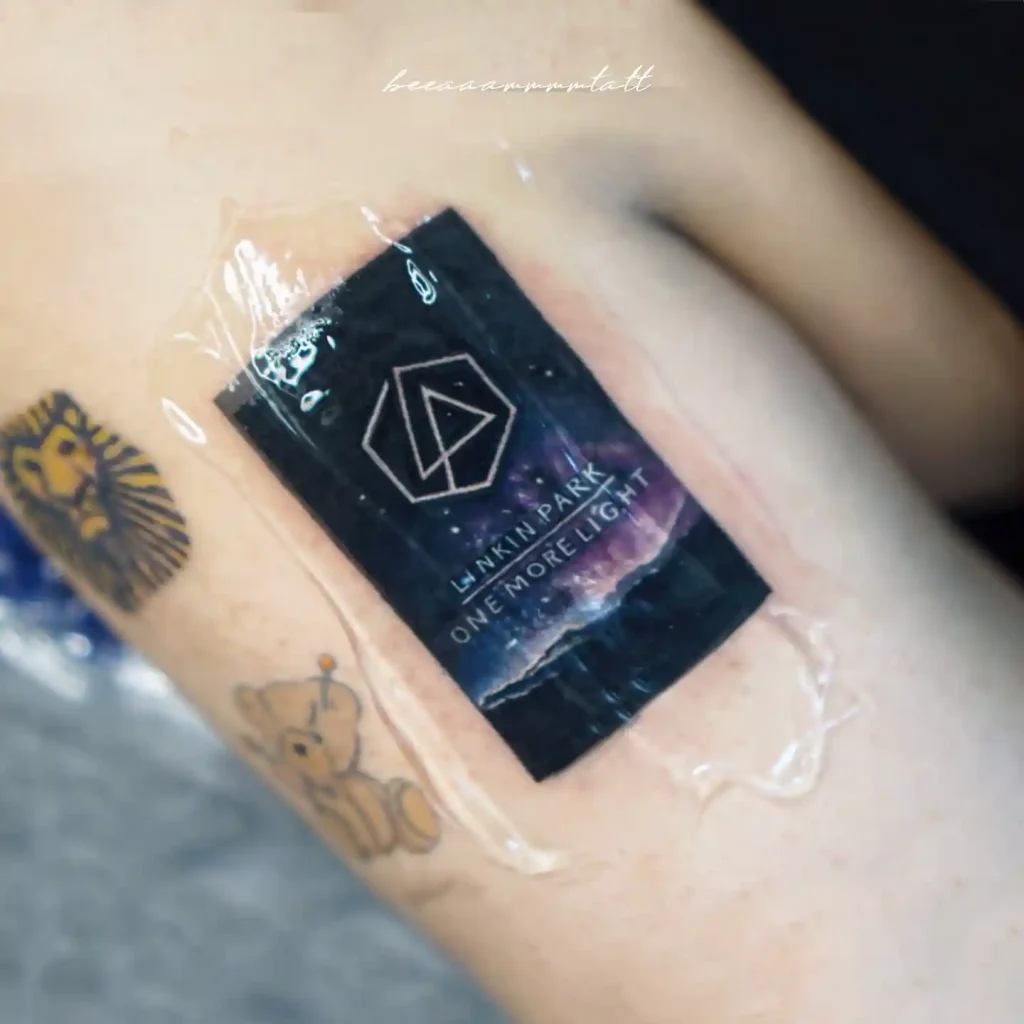Glossy Sticker Style Logo on Inner Forearm