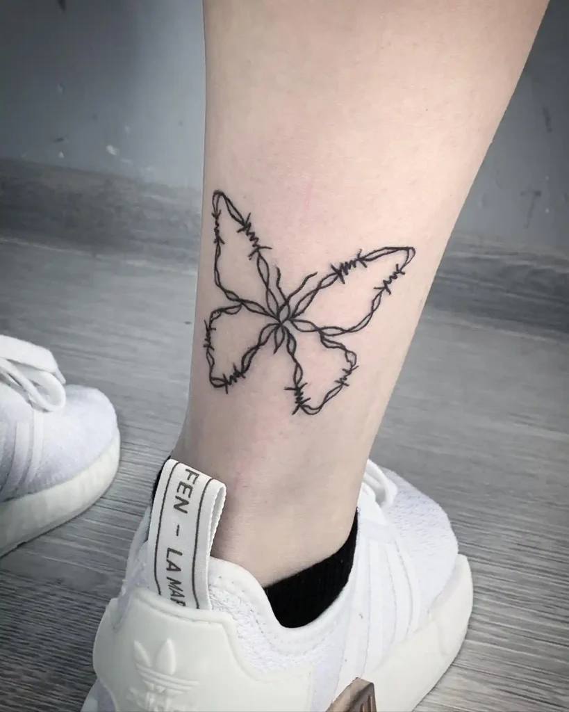 Butterfly Outline in Barbed Wire on Lower Leg