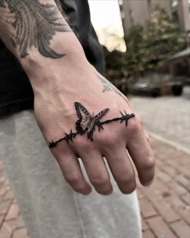 Butterfly and Barbed Wire Hand Tattoo