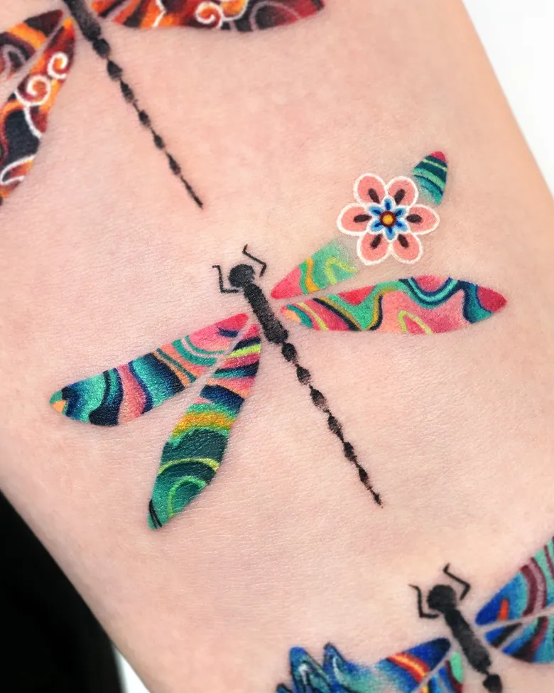 Colorful Patterned Dragonfly Tattoo on Arm