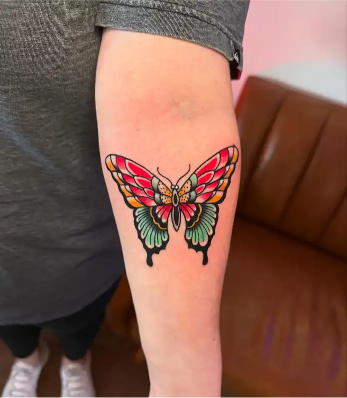 Colorful Traditional Butterfly Arm Tattoo