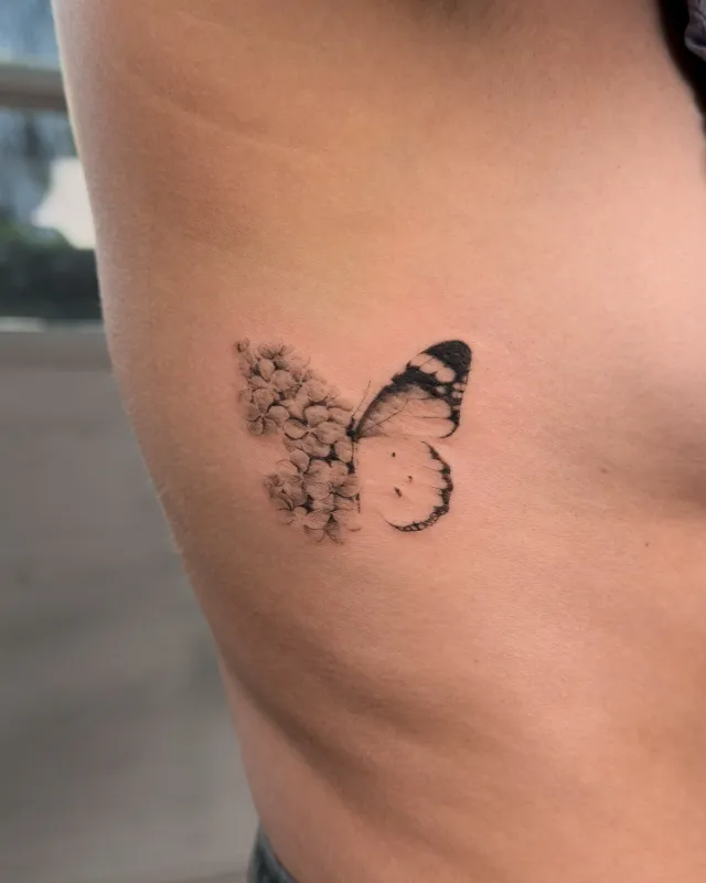 Fragmented Butterfly Fine Line Rib Tattoo