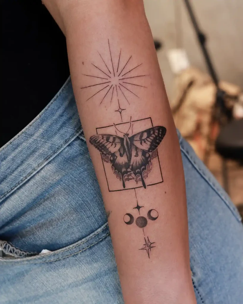 Framed Moth with Celestial Symbols on Forearm