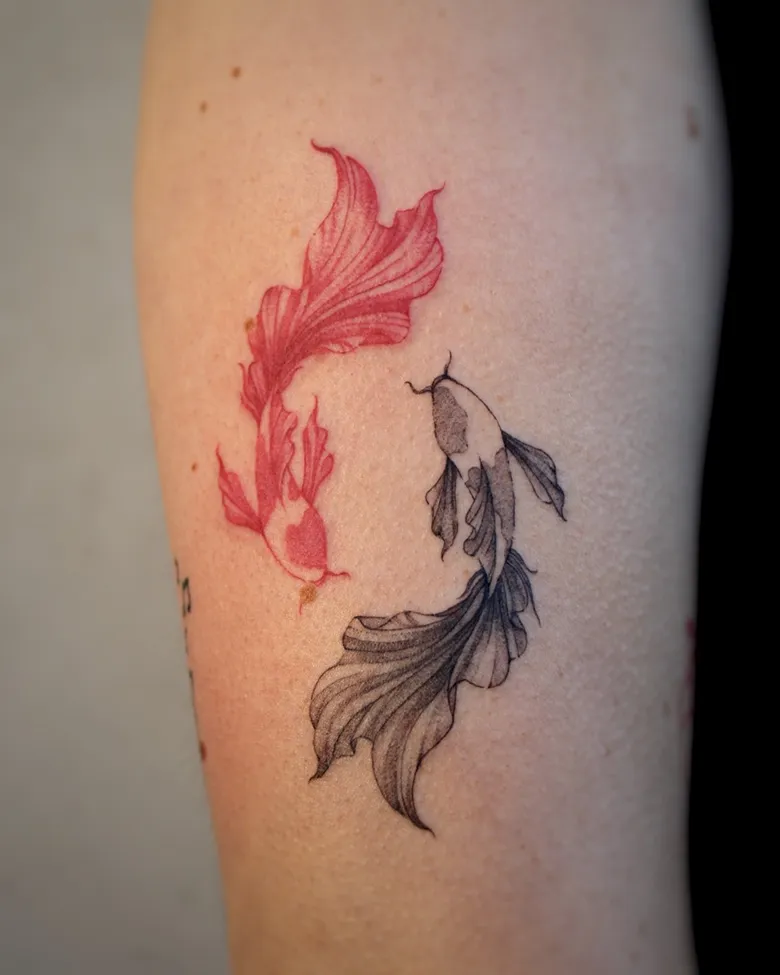 Red and Black Yin Yang Koi Fish on Arm