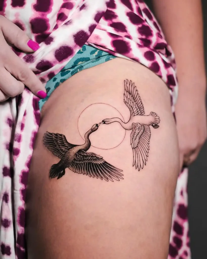 Symmetrical Flying Swans and Sun on Thigh