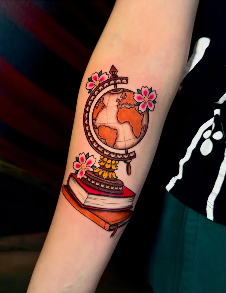 Globe Resting on Books with Cherry Blossoms