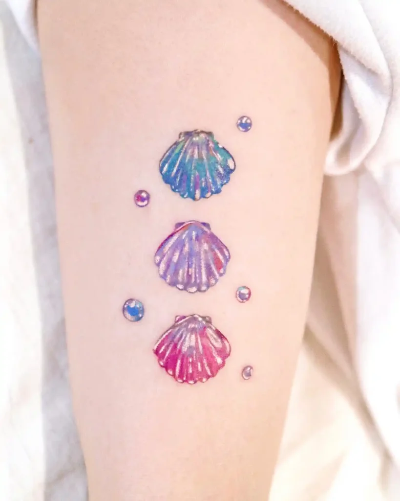 Iridescent Scallop Shell Trio on Upper Arm
