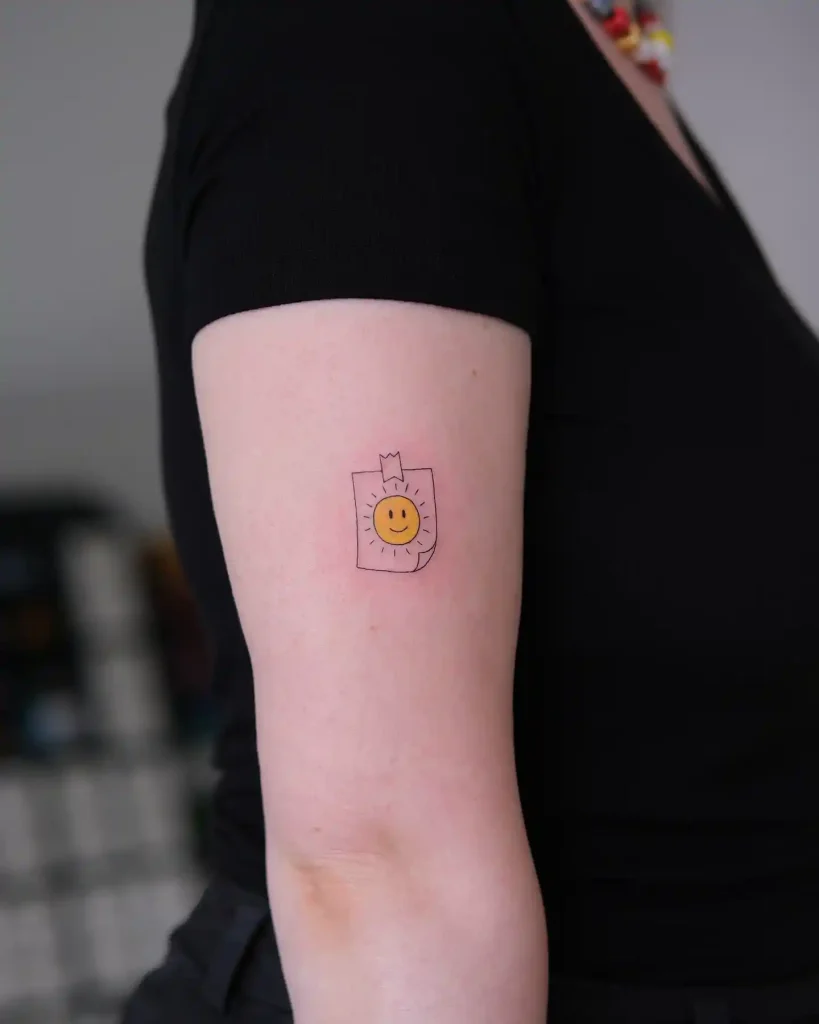 Minimalist Sun Post-it Note on Upper Arm