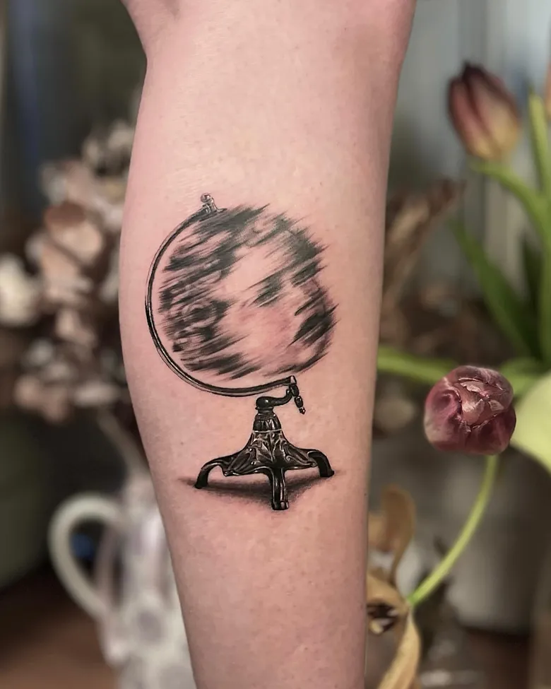 Surreal Face Within Spinning Globe Tattoo