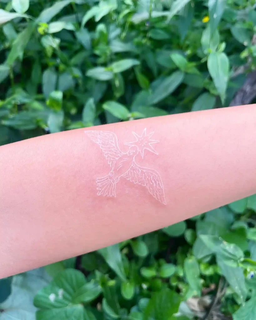 White Ink Celestial Bird on Forearm