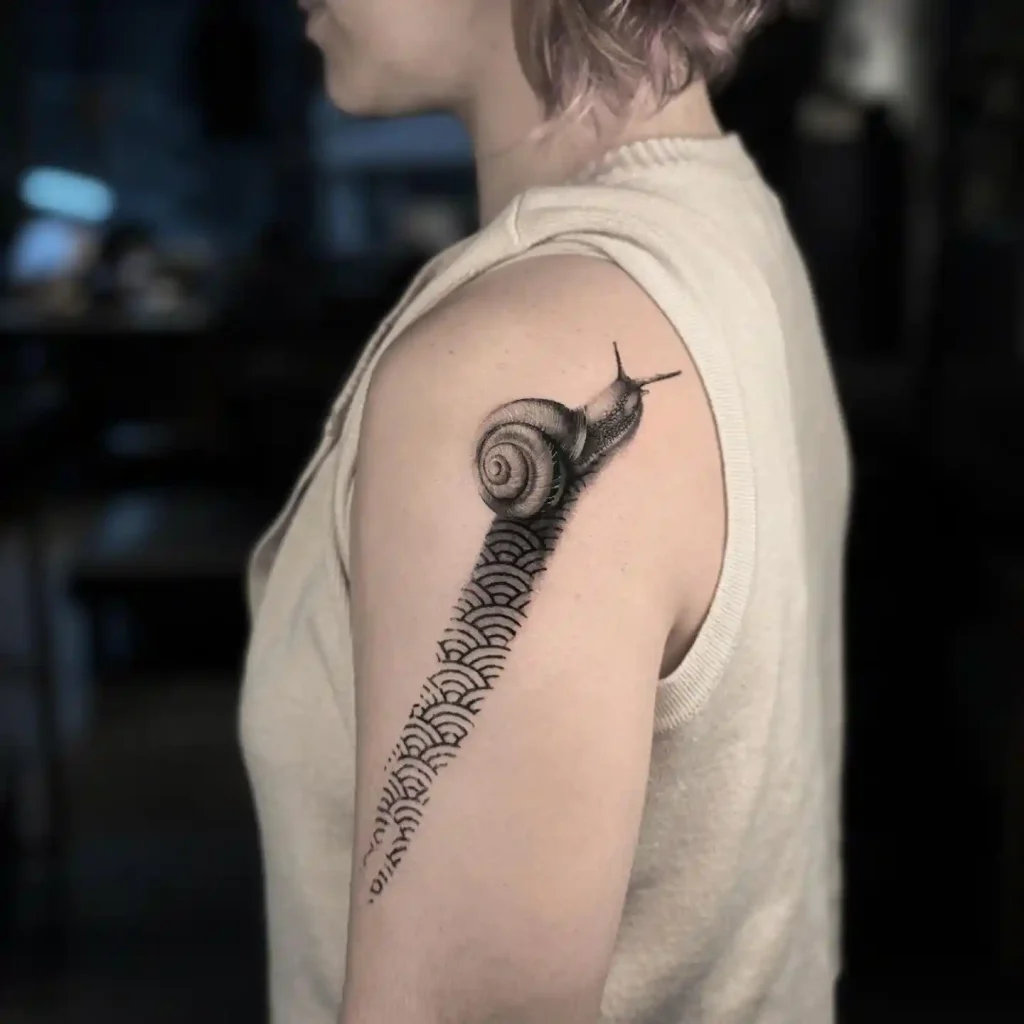 Artistic Snail with Geometric Trail on Upper Arm