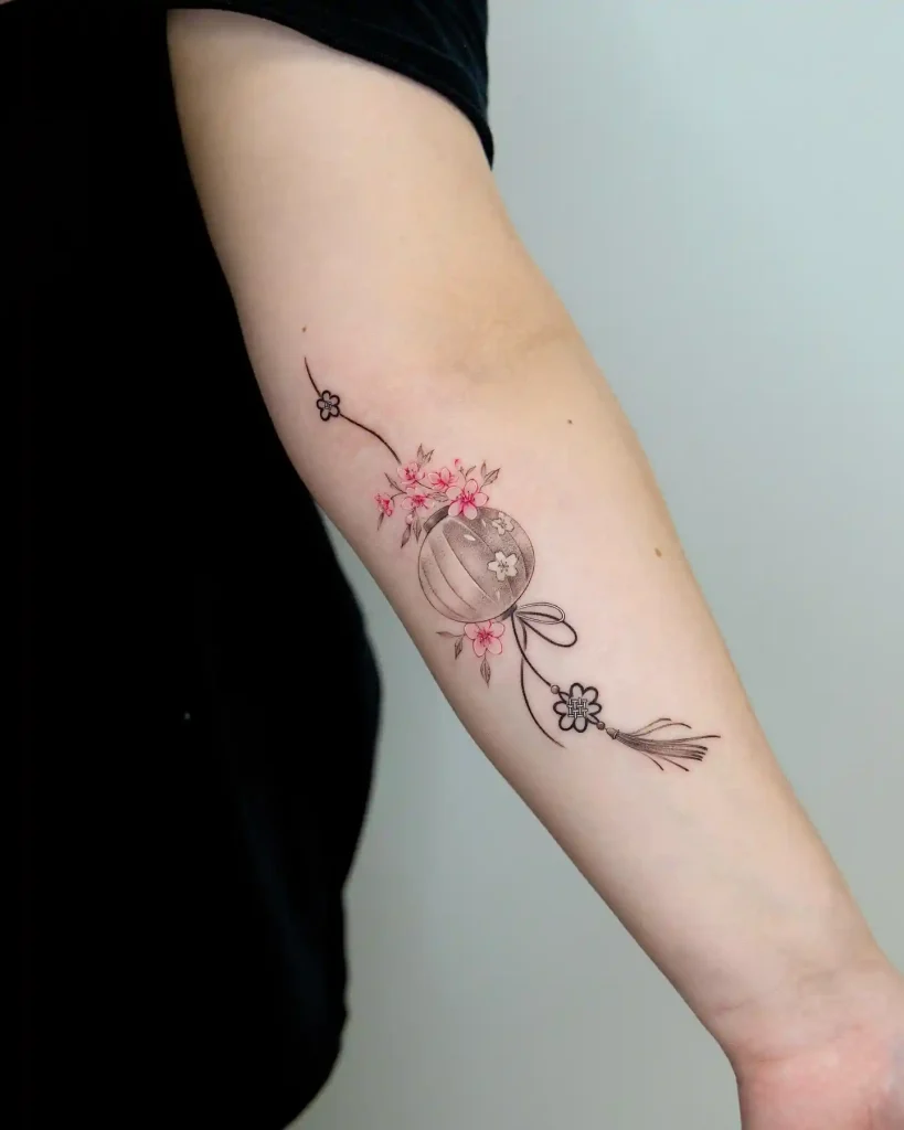Delicate Floral Lantern with Silk Tassel on Forearm