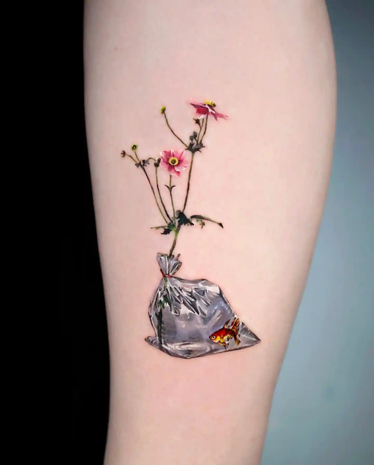 Goldfish and Pink Flowers in Water Bag on Arm