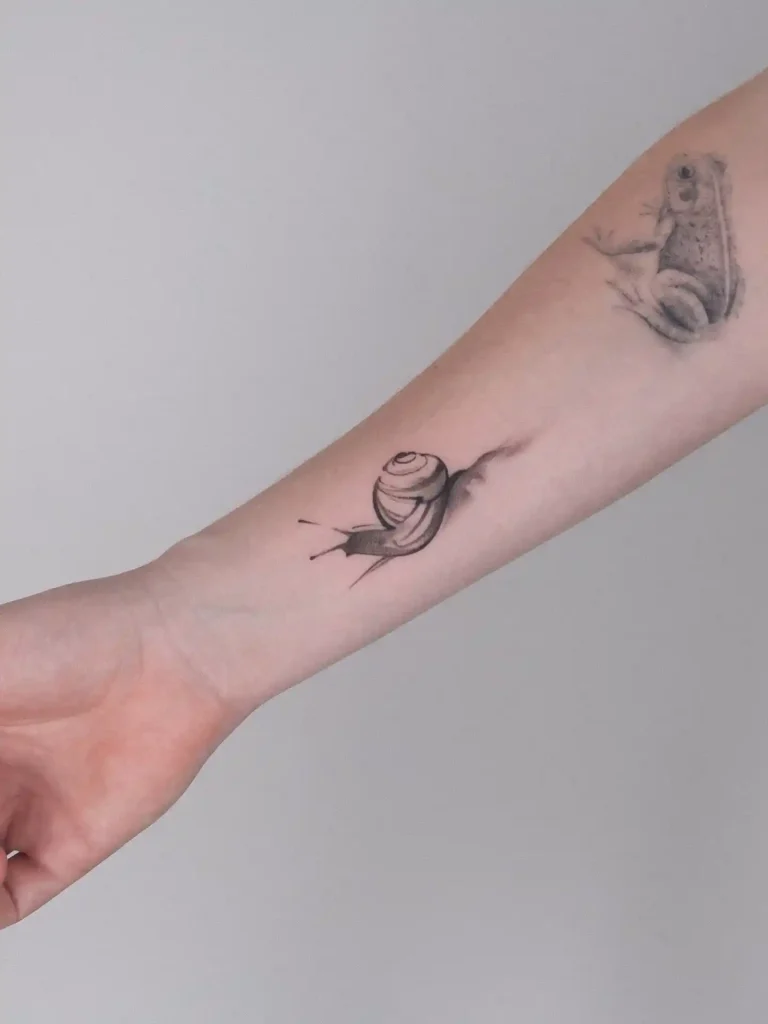 Minimalist Snail Design on Inner Forearm