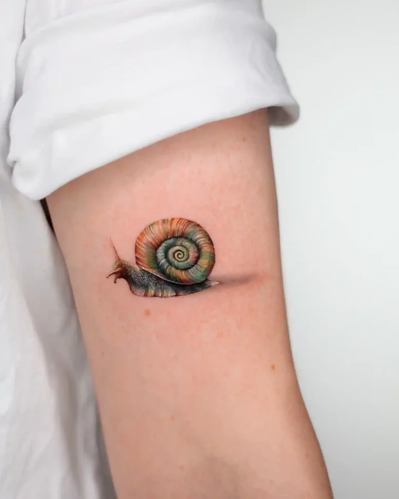 Realistic Colorful Snail Tattoo on Upper Arm