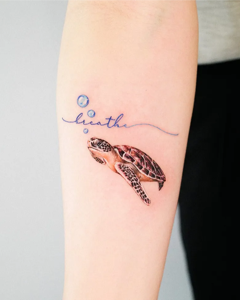 Realistic Sea Turtle Tattoo with “Breathe” Script