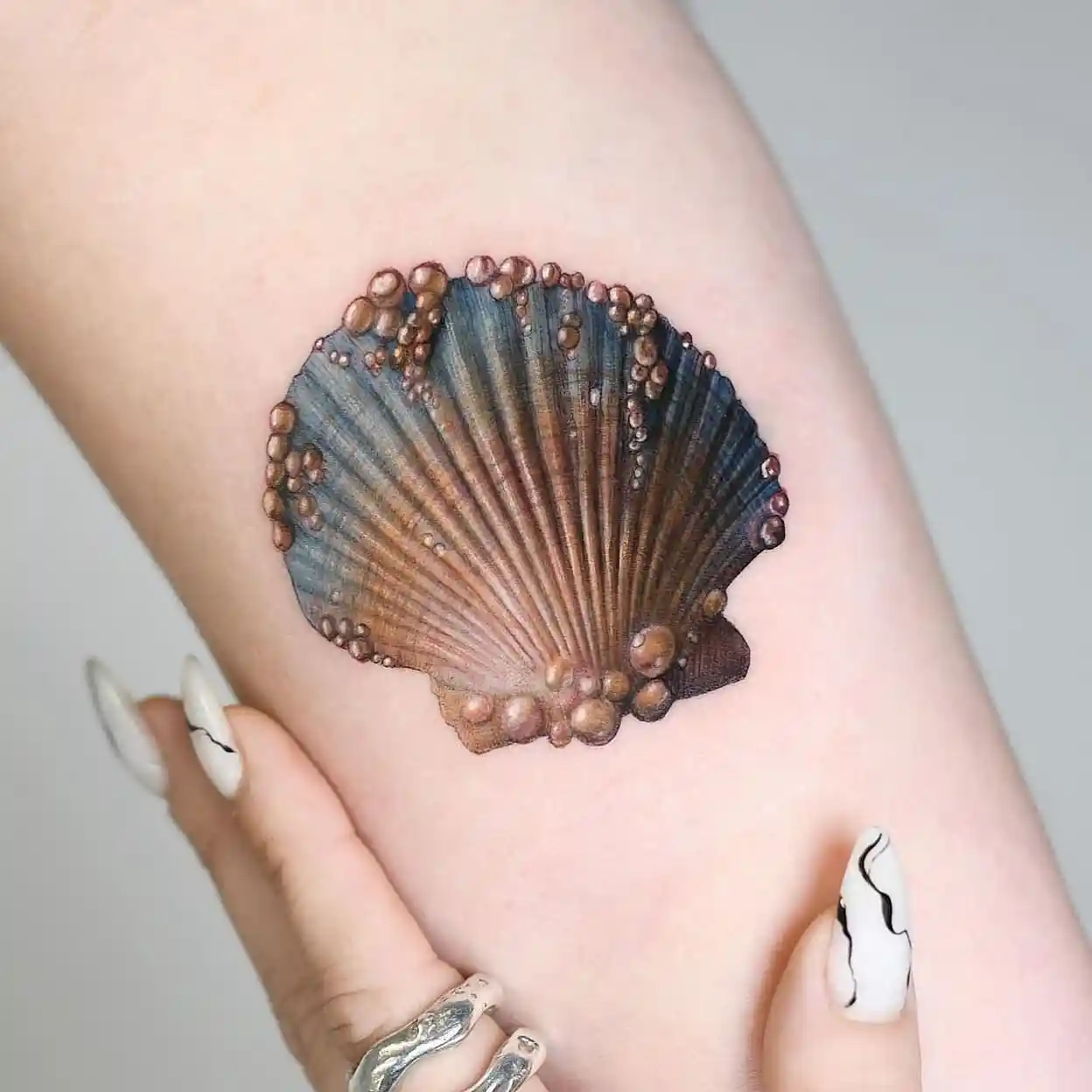Realistic Seashell with Pearls on Forearm