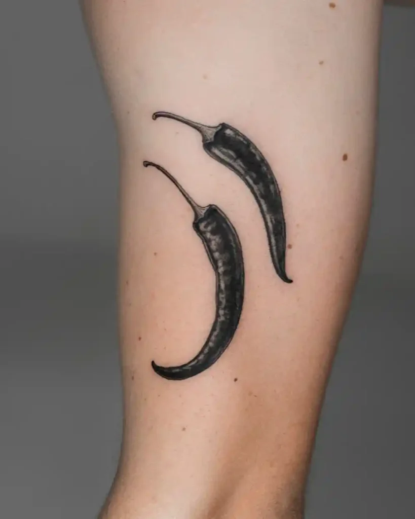 Two Realistic Chili Peppers on Arm