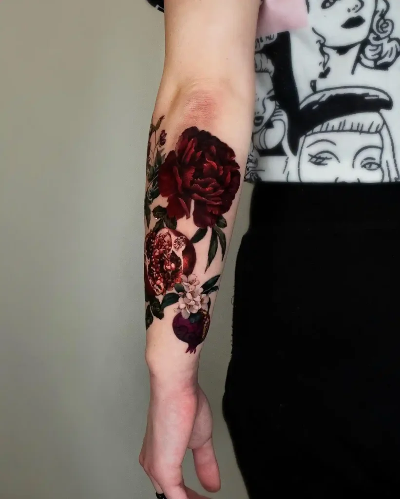 Dark Floral and Pomegranate Tattoo on Inner Forearm