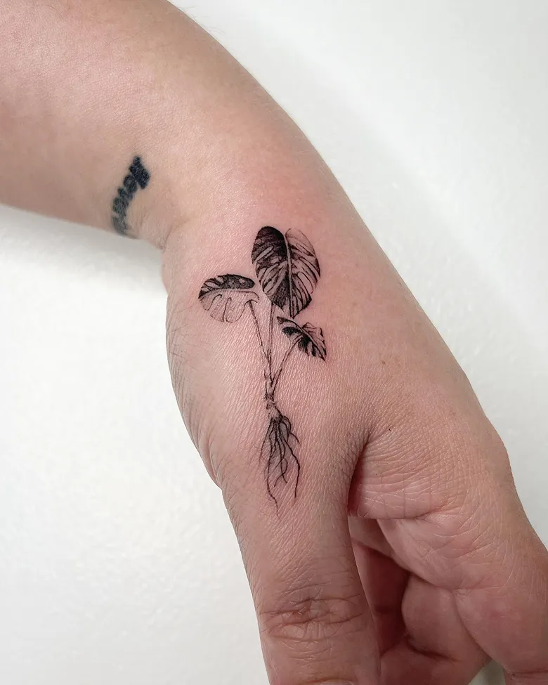Delicate Rooted Monstera Hand Tattoo