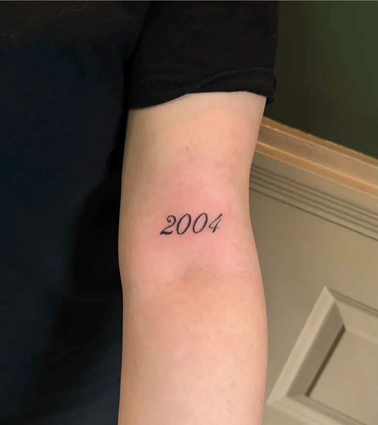 Elegant 2004 Birth Year Tattoo on the Inner Arm