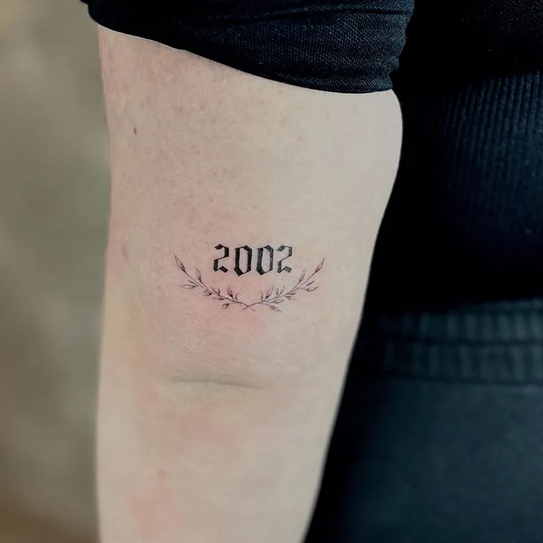 Floral 2002 Birth Year Tattoo with Gothic Font