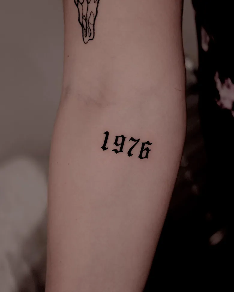 Gothic 1976 Birth Year Tattoo on Arm