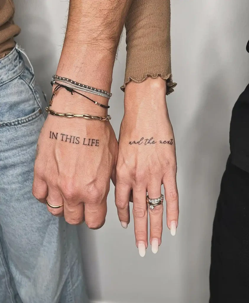 Matching Script and Serif Text Tattoos on Back of Hands