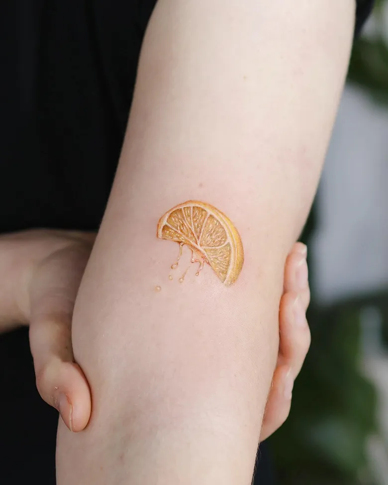 Micro Realistic Lemon Wedge Tattoo