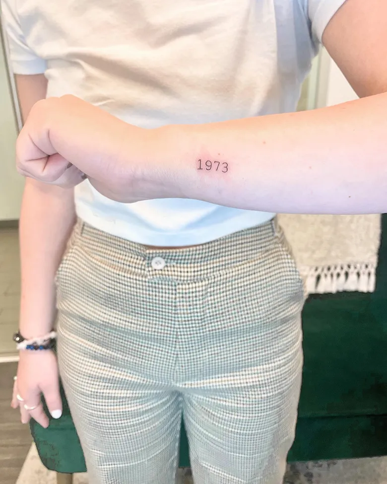 Minimal 1973 Birth Year Tattoo on the Wrist