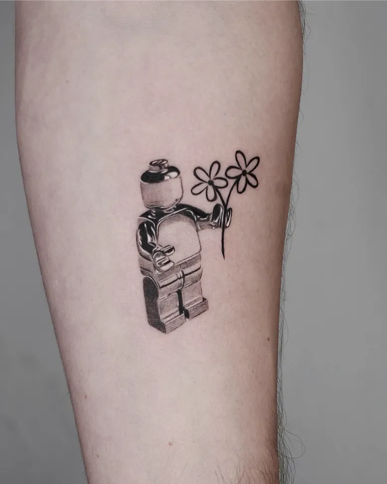 Minimal Lego Figure Tattoo Holding Flowers