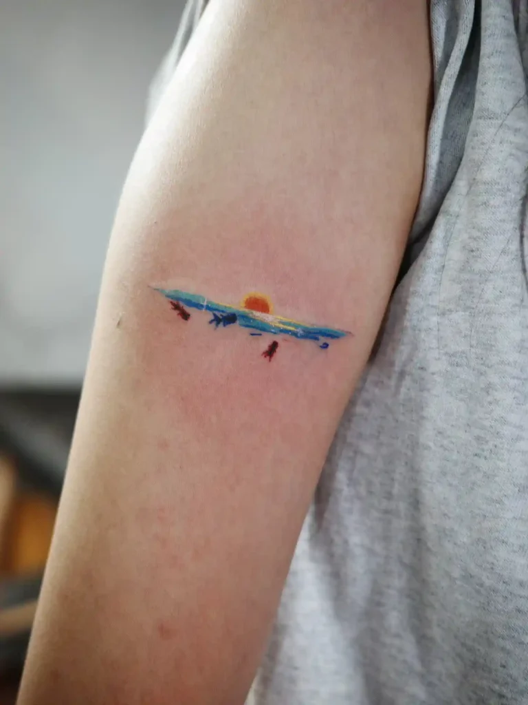 Minimalist Ocean Sunset with Fish on Upper Arm