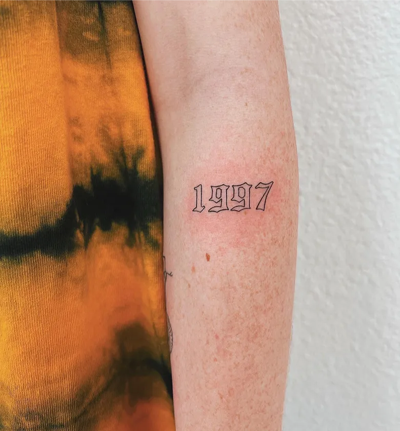 Old English Birth Year Tattoo on the Forearm