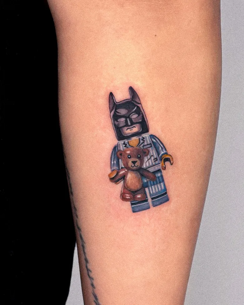 Playful Batman Lego Tattoo With Teddy Bear Charm